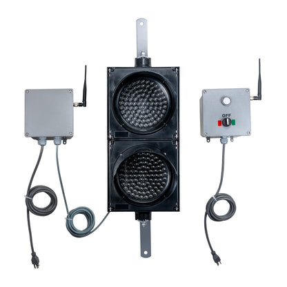 Front perspective of a wireless traffic light system with LED lights off and accompanying control box transmitter with mirrored pilot light and 2-position switch ton a white background.