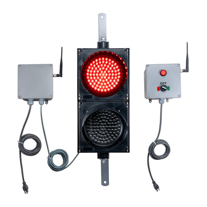 Front perspective of a wireless traffic light system with red LED light on and accompanying control box transmitter with mirrored pilot light and 2-position switch ton a white background.