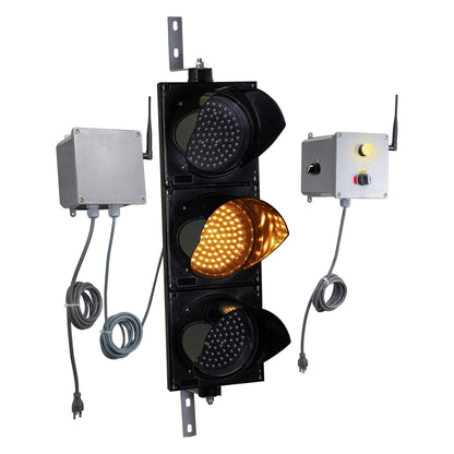 Front perspective of a wireless traffic light system with amber LED light on and accompanying control box transmitter with mirrored pilot light and 3-position switch ton a white background.