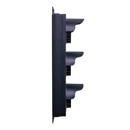 Side profile of a black triple-lens traffic light on a white background.