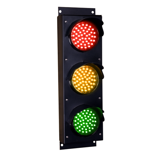Angled perspective of a red, amber and green triple-lens traffic light on a white background.